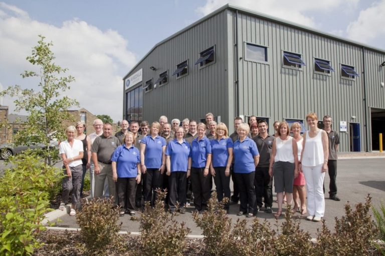 The airedale team stood together outside the manufacturing facility