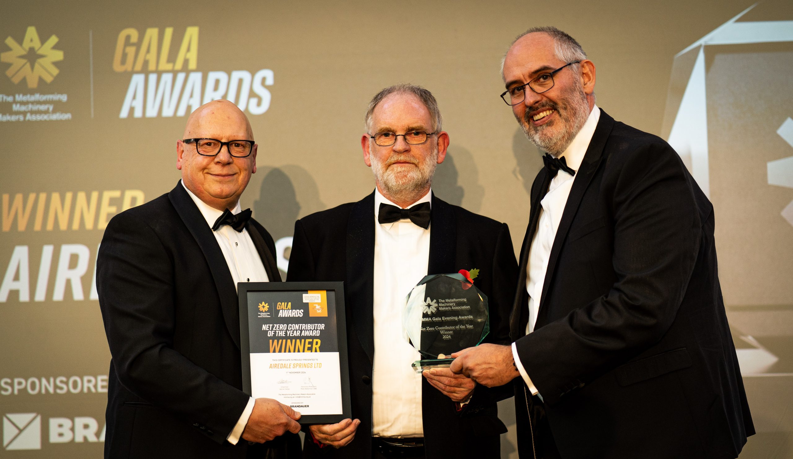 Airedale Springs Chairman, Tim Parkinson (centre), receiving the award.